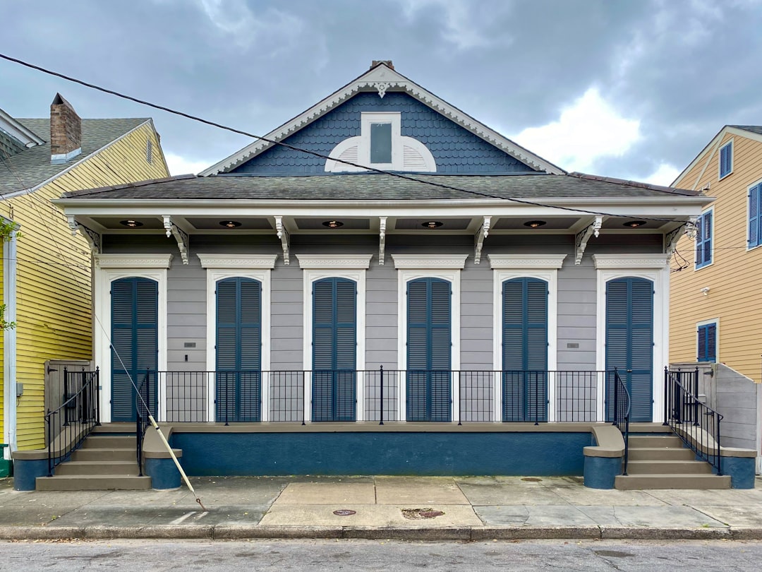 Classic Louisiana home with a prominent, well-maintained roof under a bright, sunny sky, representing a valuable real esta...